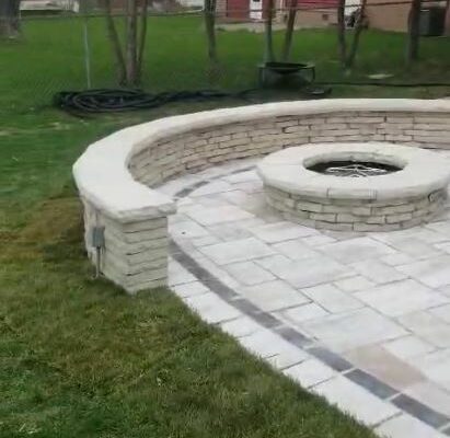 Backyard patio with gas fire pit and a half-moon sitting wall Arlington Heights